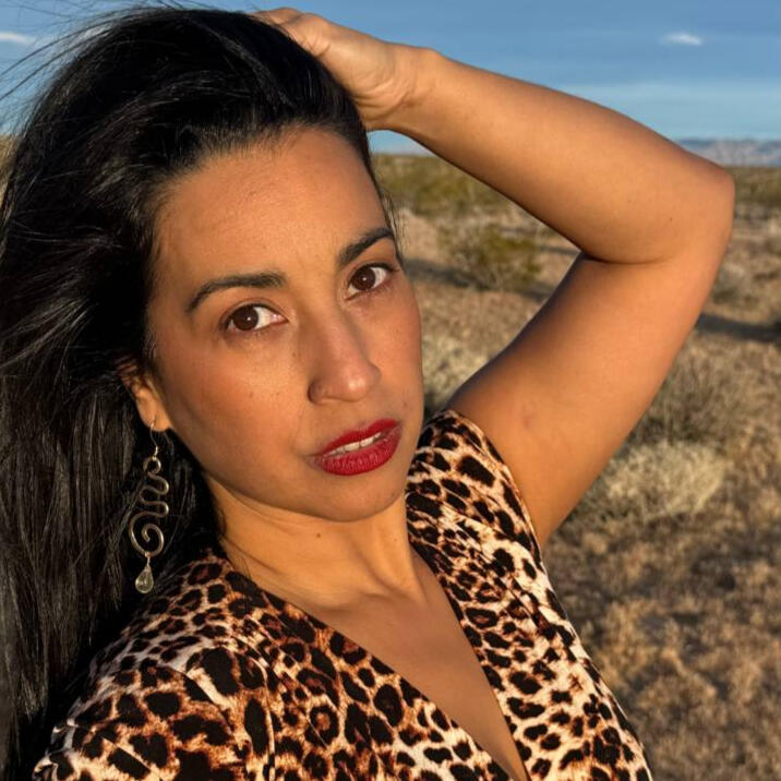 Jessy Furniel during golden hour at Joshua Tree with dessert background and red lipstick.